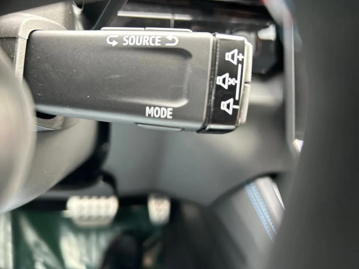 Gros plan sur la commande au volant noir avec marquages blancs dans l'habitacle du Renault Rafale noir 2025.