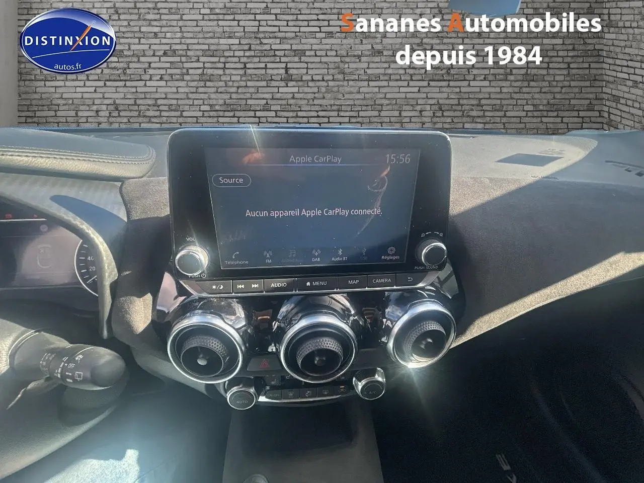 Vue intérieure du tableau de bord du Nissan Juke 2020 Tekna, avec écran tactile et commandes circulaires de climatisation.