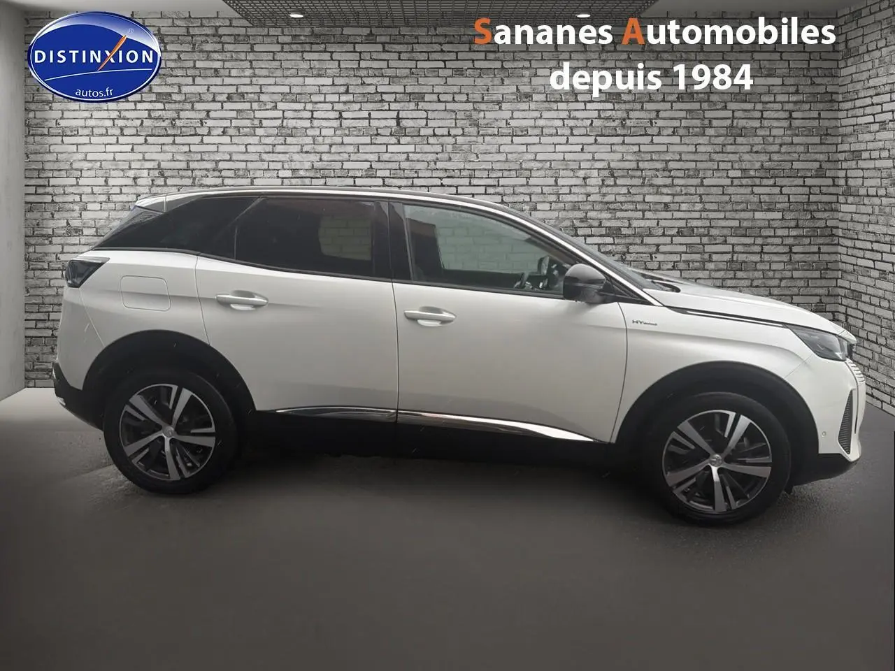 Profil côté gauche d’un Peugeot 3008 Hybrid blanc avec toit noir et jantes alliage dans un showroom.