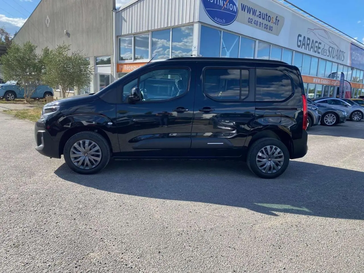 Vue de profil côté gauche d'un Citroën Berlingo noir 2026, avec portes latérales coulissantes et vitres surteintées.