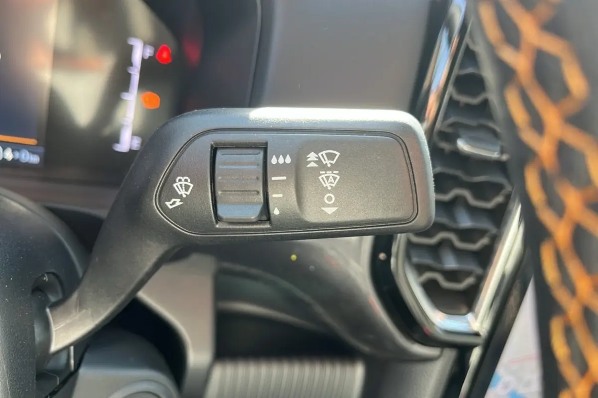 Gros plan sur la commande des essuie-glaces du Ford Ranger PHEV 281 Wildtrak gris carbone, intérieur avec surpiqûres orange.