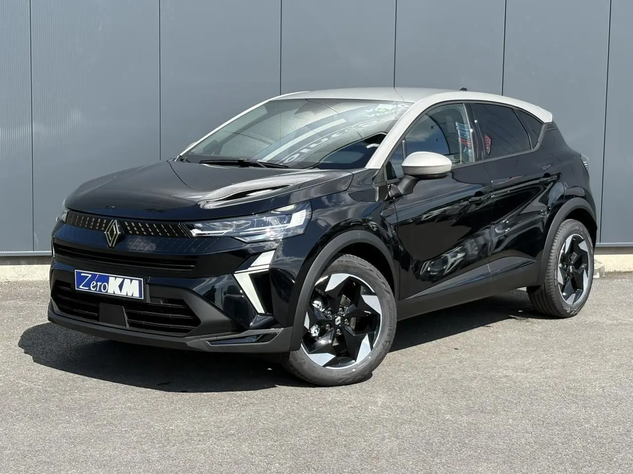 Renault Captur 2025 bicarburation noir étoile vue 3/4 avant droit avec toit grège perle et jantes noires.