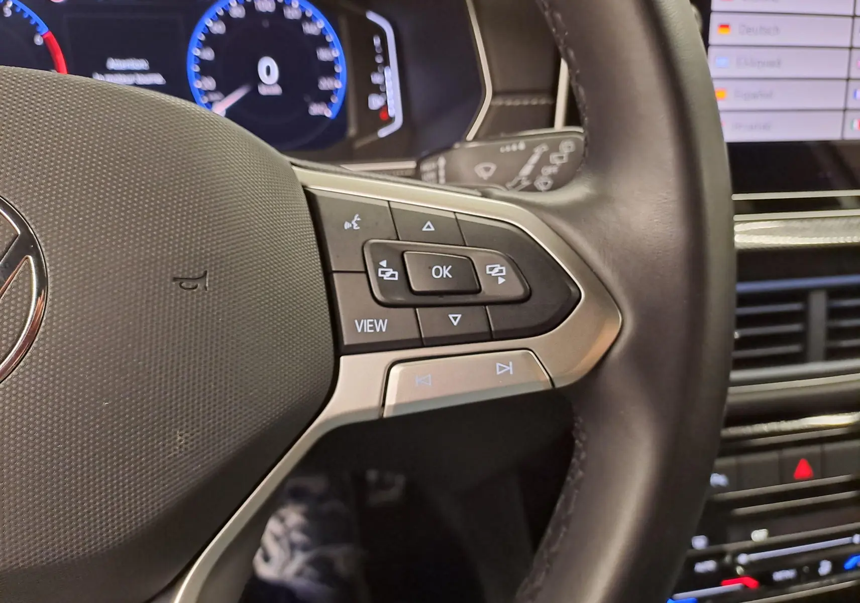 Gros plan sur le volant côté droit du Volkswagen T-Cross 2025 R-Line Edition en intérieur, avec commandes intégrées.