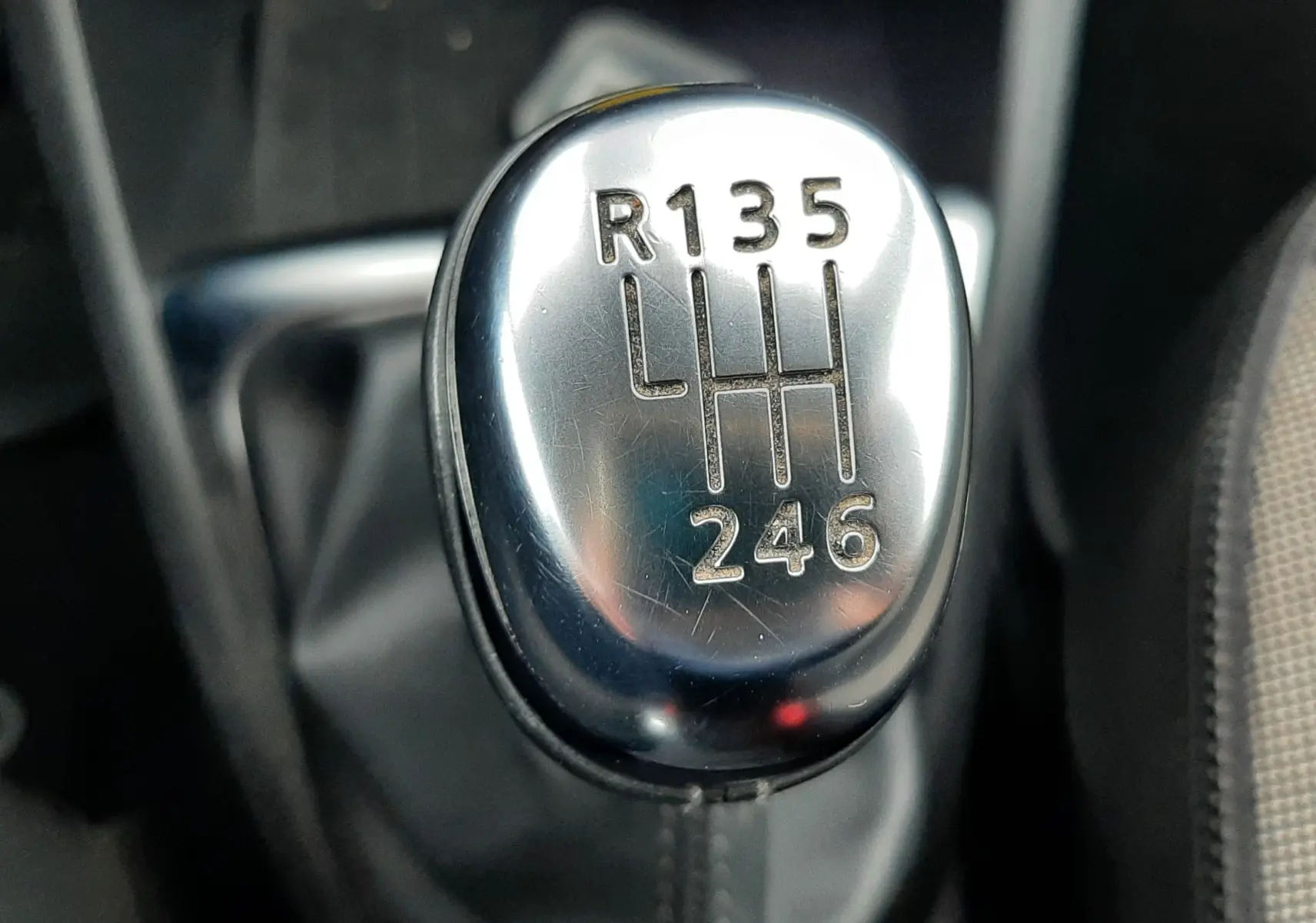 Gros plan sur le levier de vitesses manuel chromé du Renault Captur gris 2017, avec marquage des rapports visibles.
