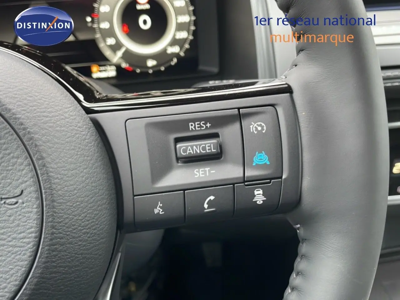 Gros plan sur le volant en cuir noir du Nissan Qashqai 2025, montrant les commandes de régulateur de vitesse.