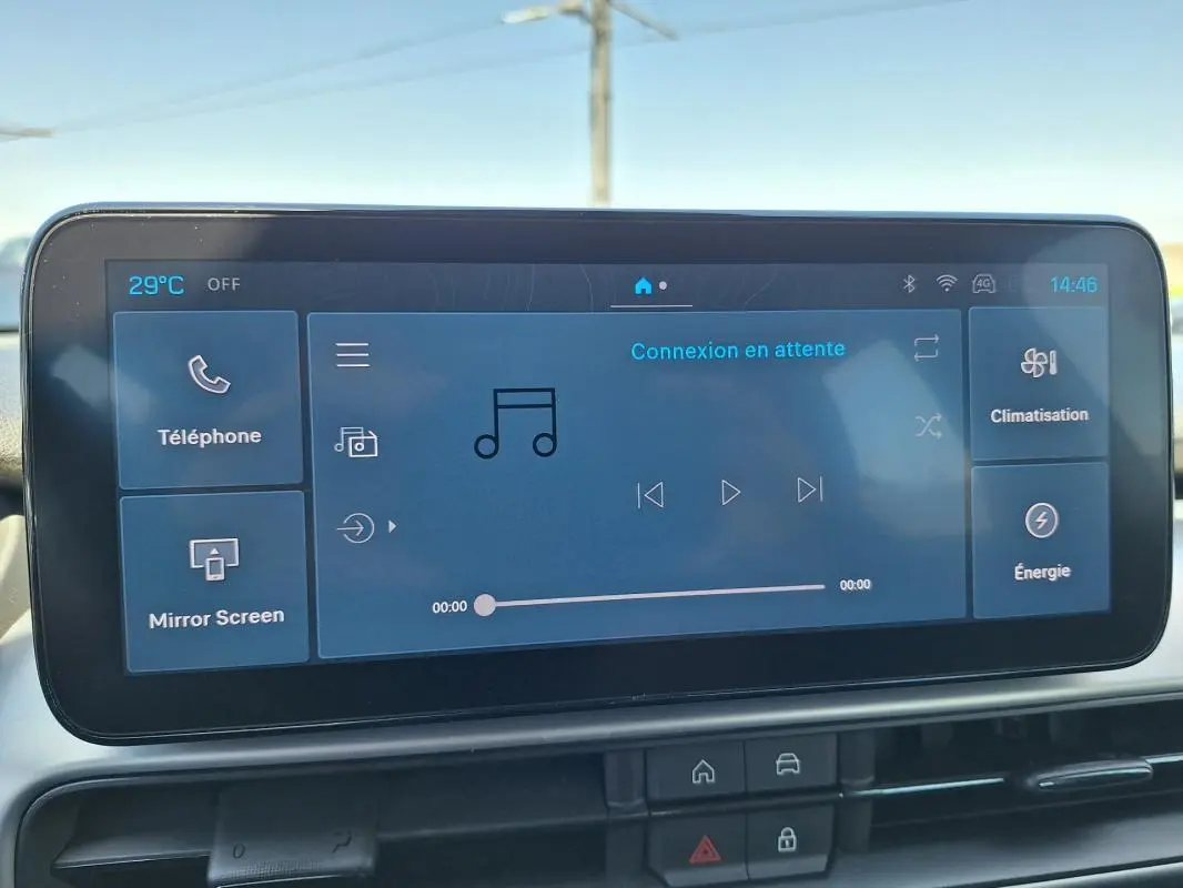 Écran tactile central du Jeep Avenger blanc, affichant l’interface multimédia avec commandes de musique et climatisation.