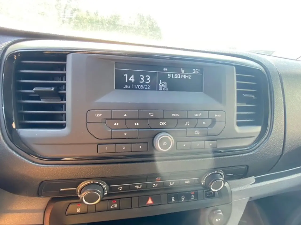 Tableau de bord du Fiat Scudo Fourgon blanc 2022, avec écran radio et commandes climatisation visibles de face.
