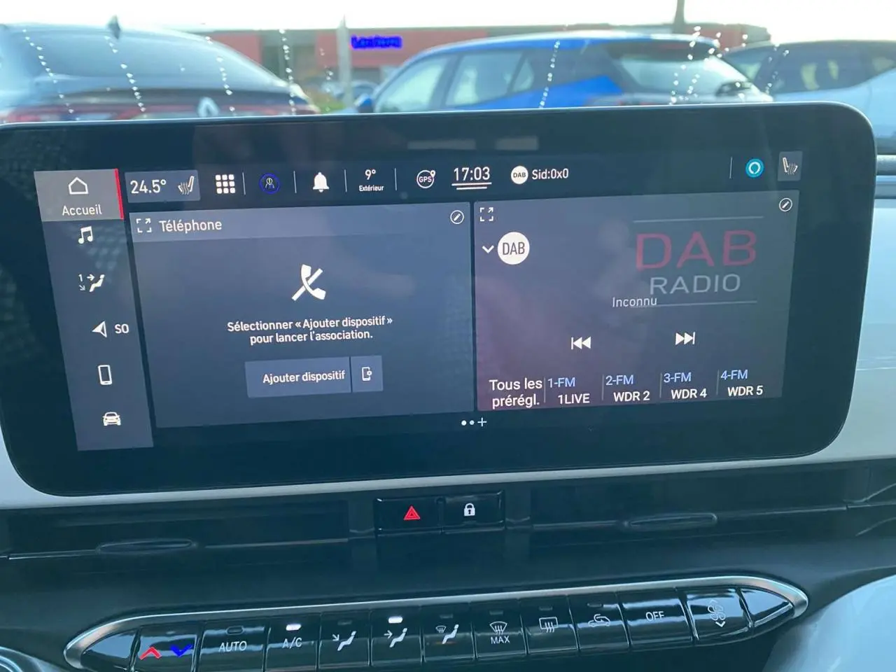 Écran tactile central du tableau de bord de la Fiat 500 électrique blanc, affichant les options téléphone et radio DAB.