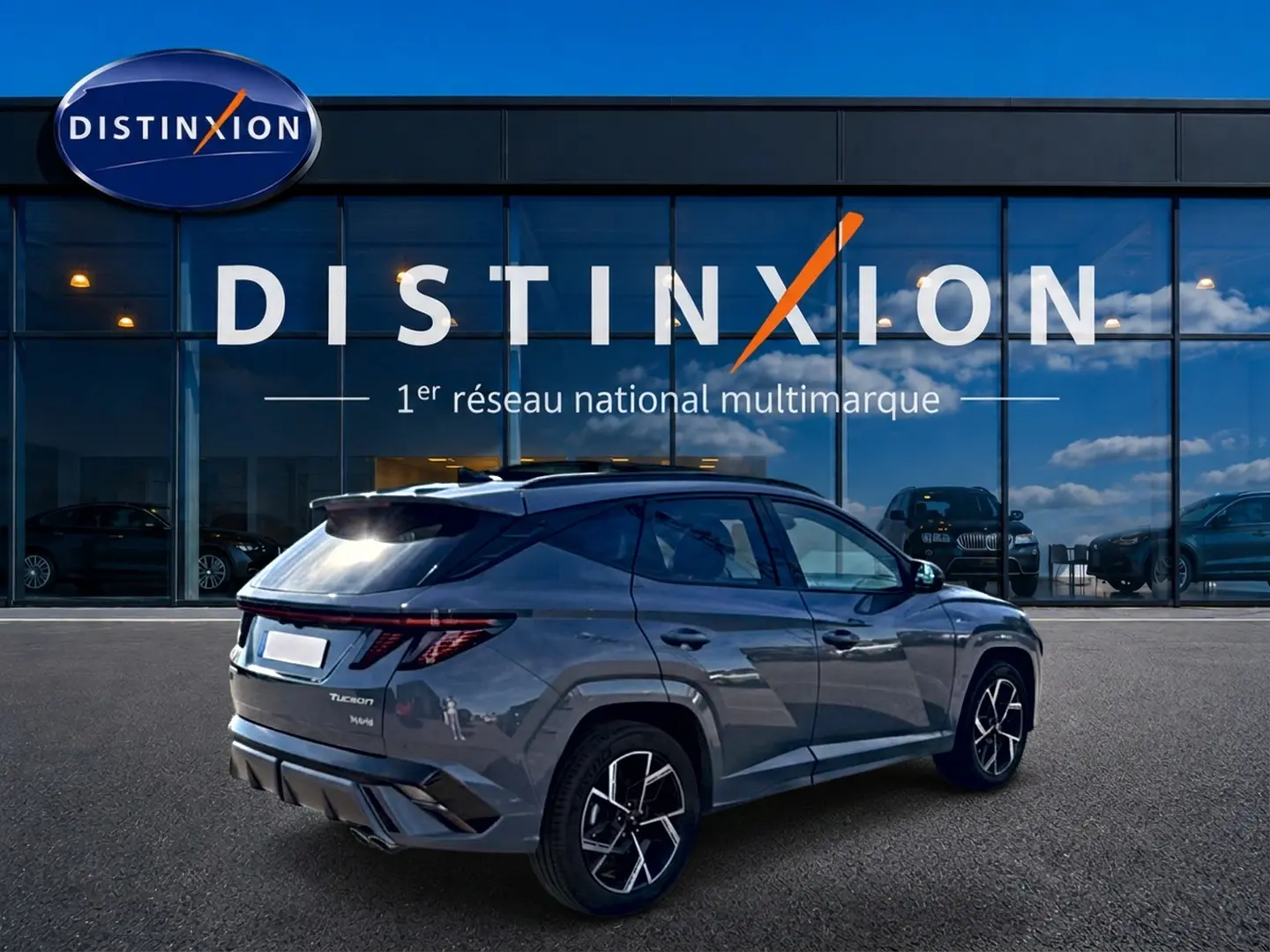 Hyundai Tucson 1.6 t-gdi 239 hybride gris shadow en 3/4 arrière droit, avec jantes alu et feux LED distinctifs.