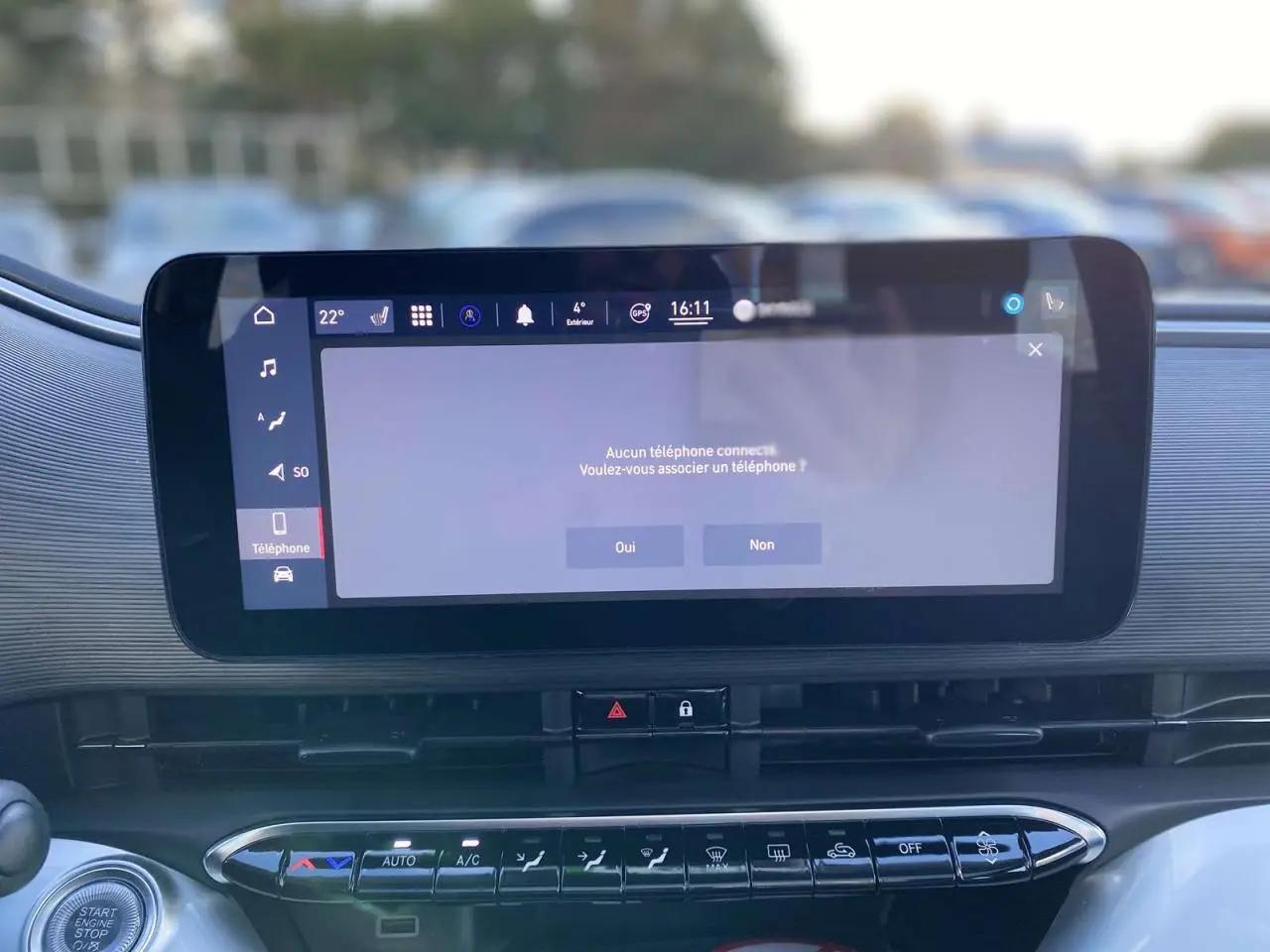 Écran tactile central allumé dans l'habitacle de la FIAT 500 électrique noire, vue de face rapprochée.