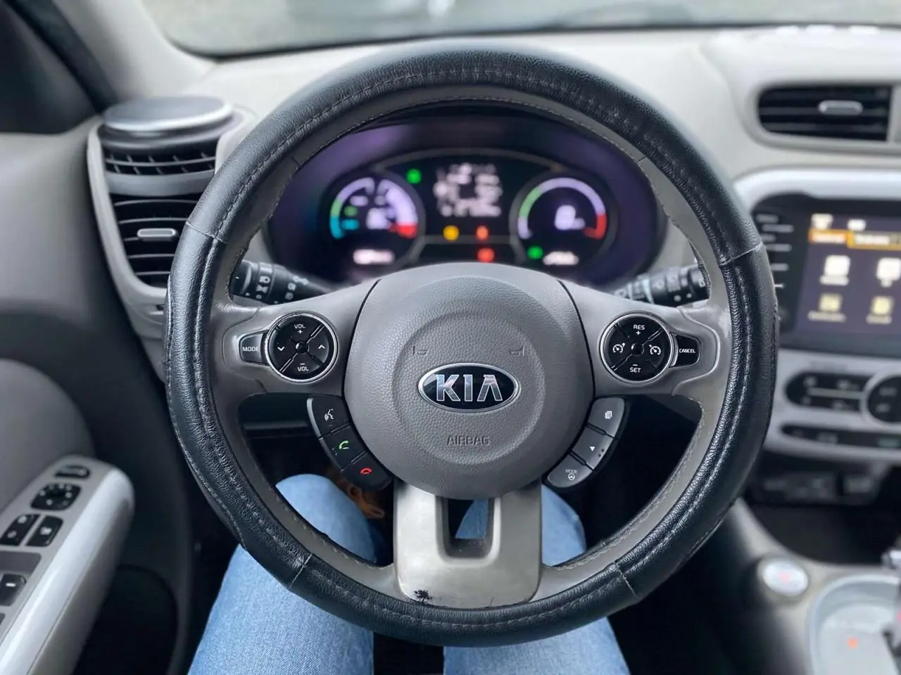 Vue intérieure centrée sur le volant KIA d'un Soul électrique 2016, avec tableau de bord et commandes visibles.