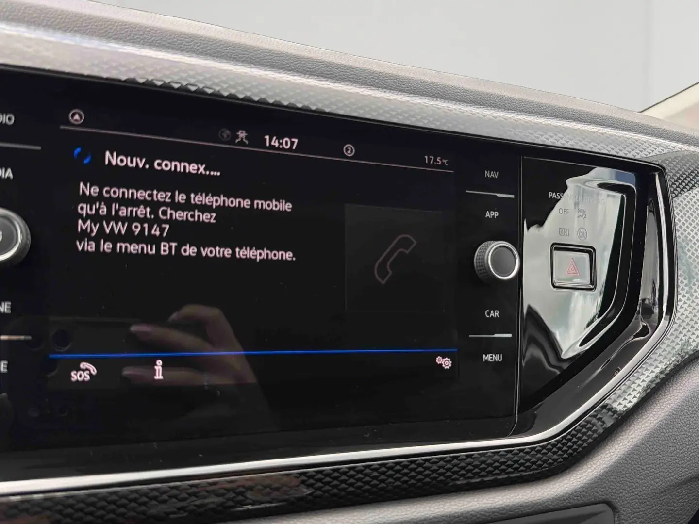Vue rapprochée de l'écran tactile noir du système infotainment de la Volkswagen Polo grise 2025 avec commandes latérales.