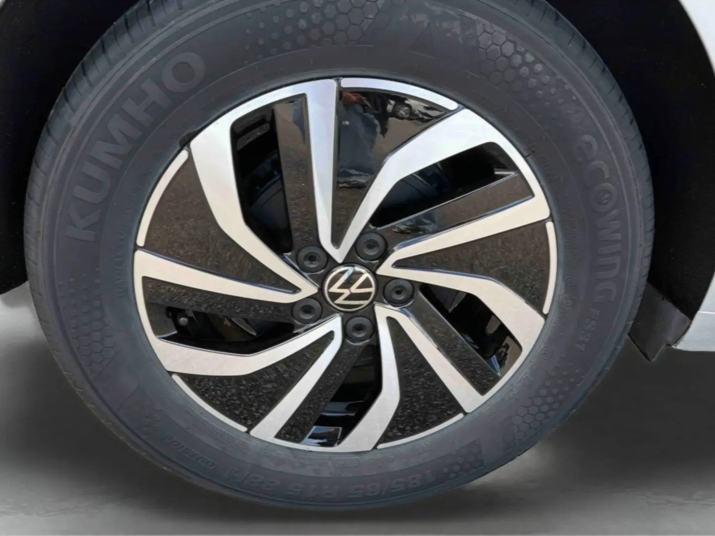 Gros plan sur la jante alliage 15 pouces bicolore noir et argent de la Volkswagen Polo grise 2025.