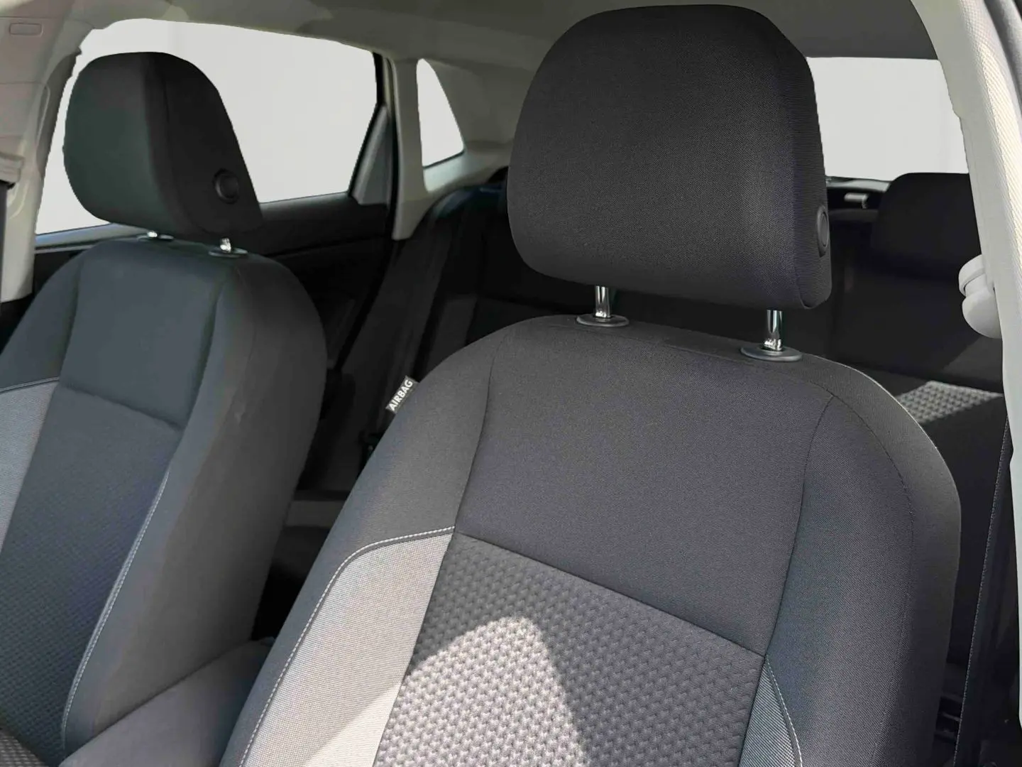 Gros plan sur les sièges avant gris foncé et clair de la Volkswagen Polo 2025, vue côté passager.