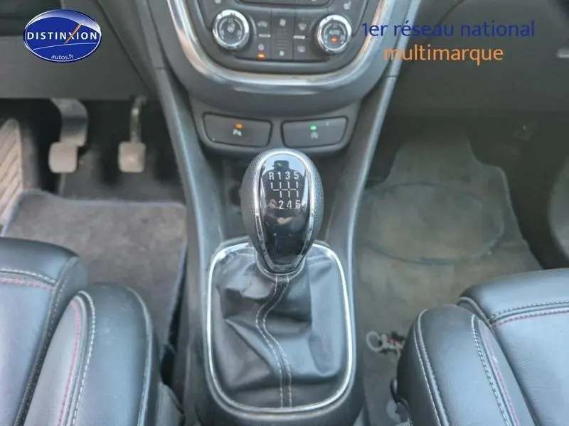 Gros plan sur le levier de vitesses manuel noir et cuir dans l’habitacle d’un Opel Mokka gris Astéroïde.