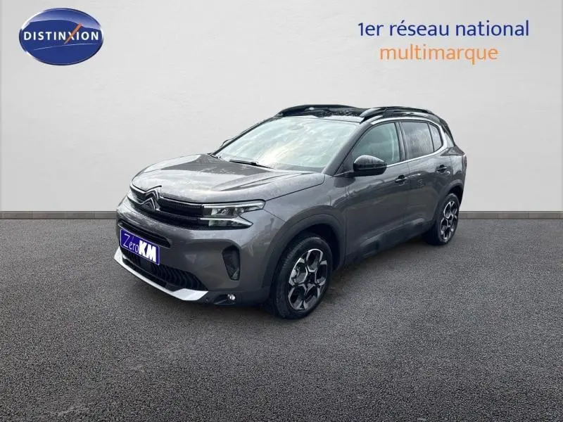 Citroën C5 Aircross gris Platinium vue 3/4 avant droit avec jantes alu et barres de toit noires