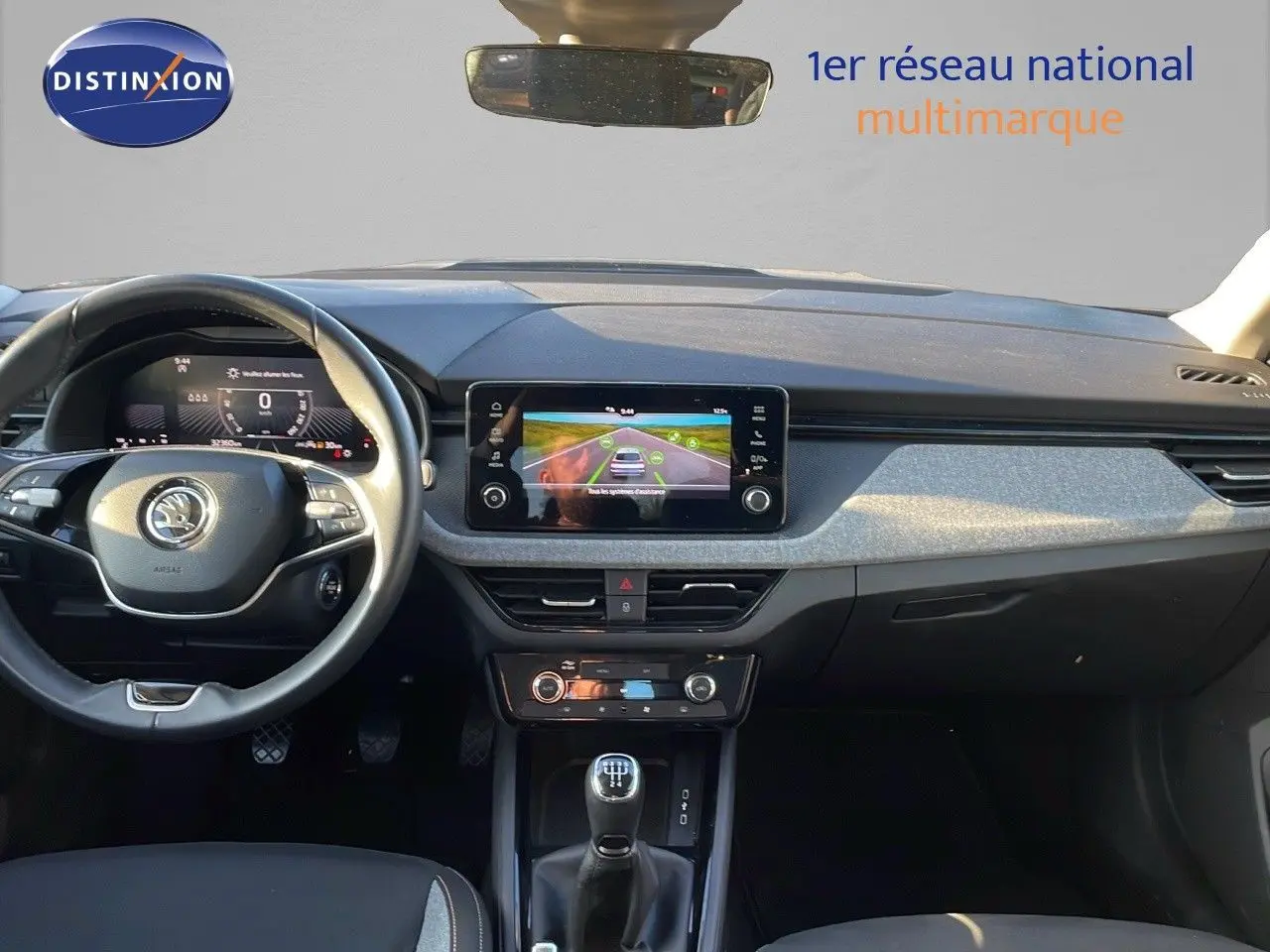 Intérieur du Skoda Kamiq 2024 noir magique métal, vue frontale sur le tableau de bord et la console centrale avec boîte manuelle.