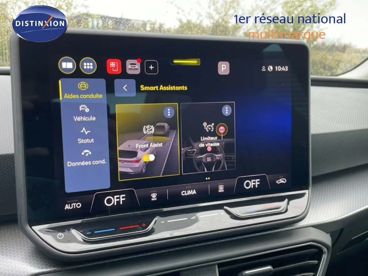 Écran tactile central affichant les aides à la conduite dans l’habitacle d’une SEAT LEON gris magnétique, vue de face.