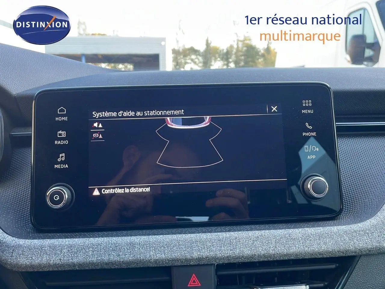 Écran tactile central du Skoda Kamiq gris graphite montrant le système d'aide au stationnement en intérieur.