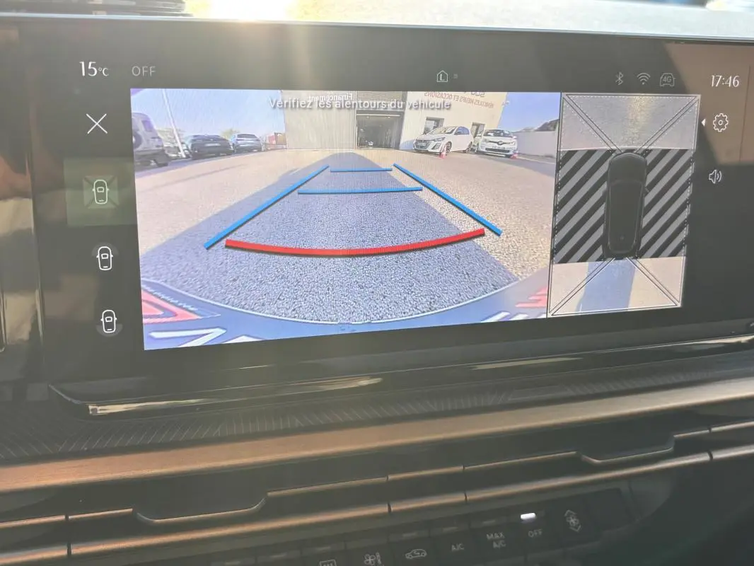 Écran intérieur de la Lancia Ypsilon 2025 montrant la caméra de recul avec guidage dynamique en vue arrière.