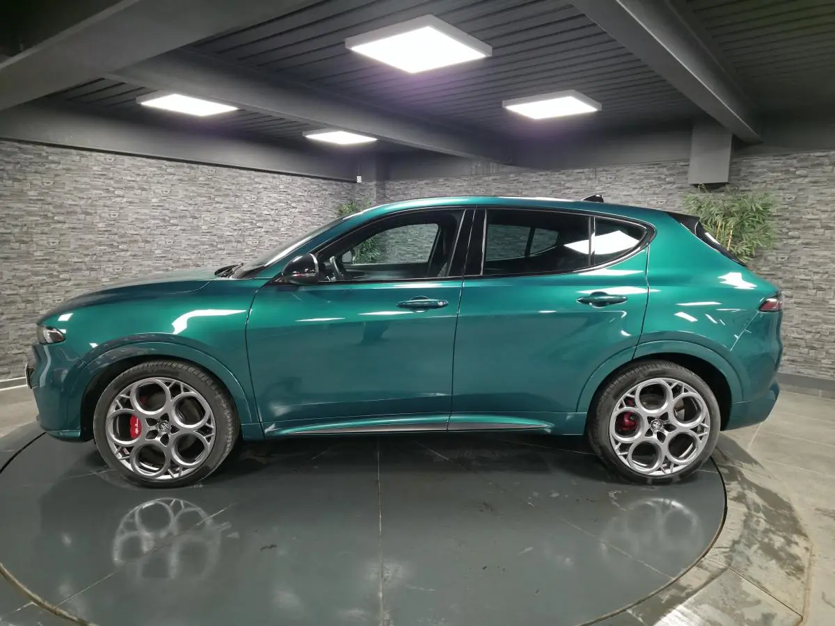 Profil côté gauche de l'Alfa Romeo Tonale 2024 vert Montreal avec jantes alliage 20 pouces et étriers de frein rouges.