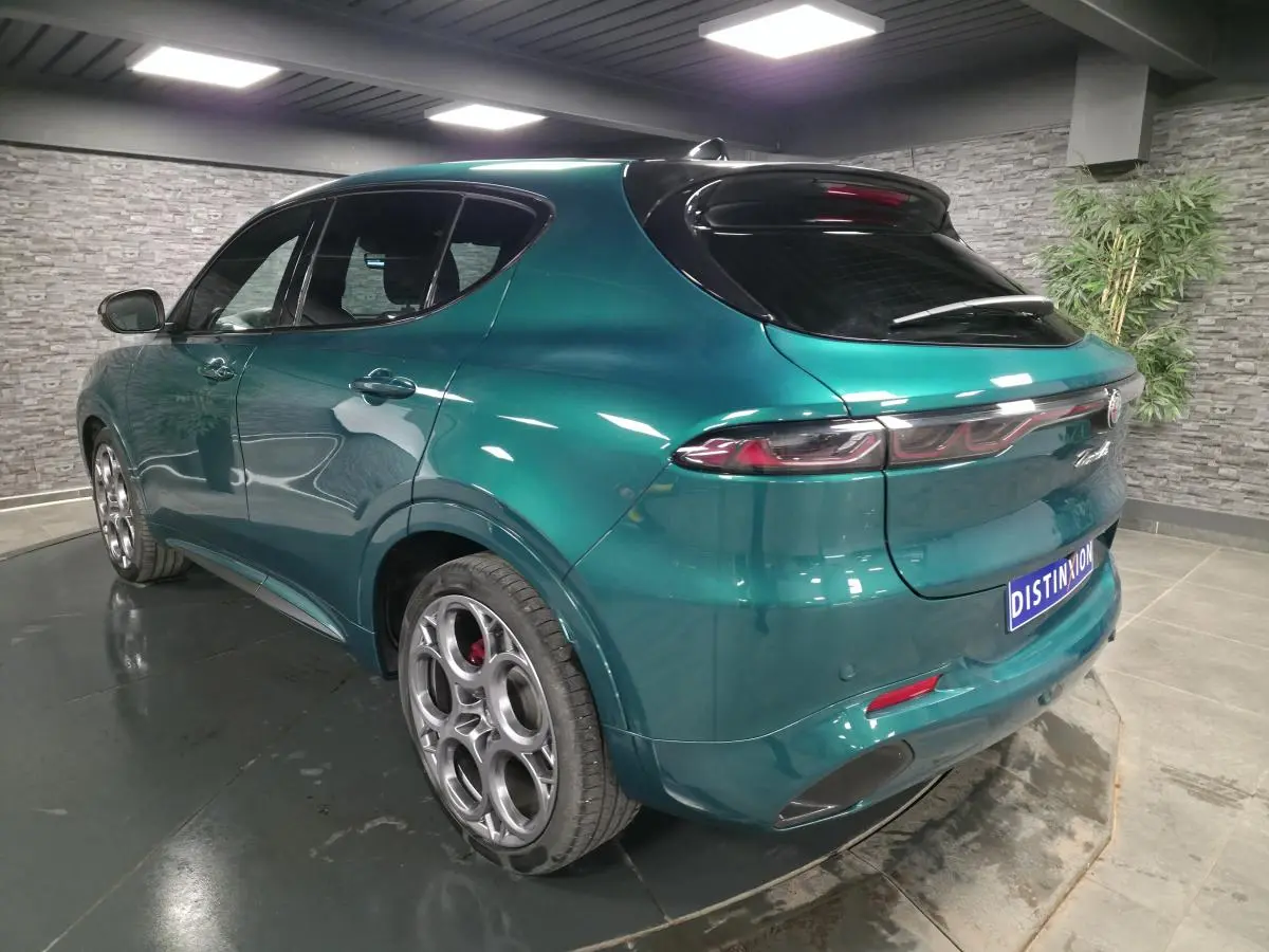 Vue 3/4 arrière droite d'une Alfa Romeo Tonale 2024 vert Montreal avec jantes 20 pouces et toit noir.