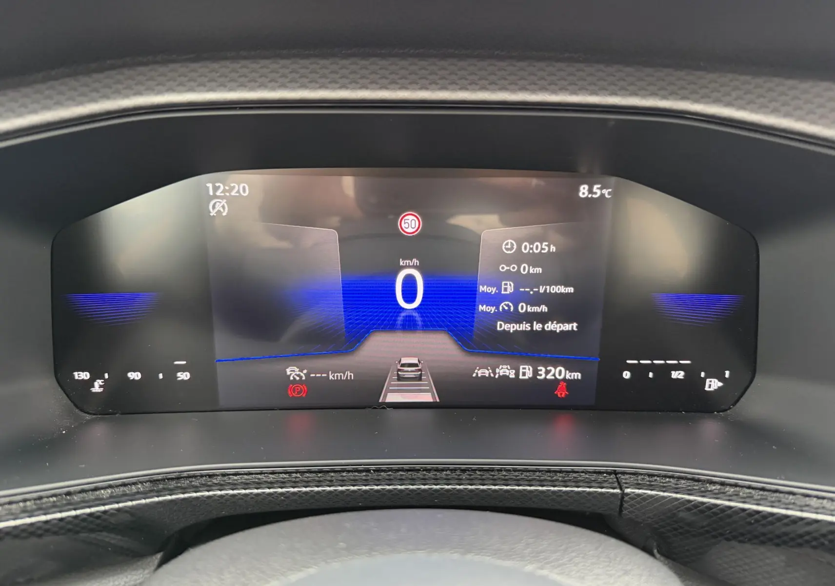 Combiné d'instruments digital du Volkswagen T-Cross 2025 affichant vitesse, autonomie et alertes, vue frontale rapprochée.