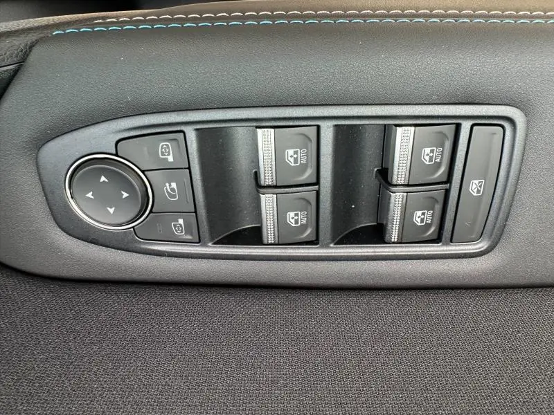 Panneau de commandes des vitres électriques et rétroviseurs sur la porte intérieure d’un Renault Captur gris Cassiopée/Noir Étoilé.