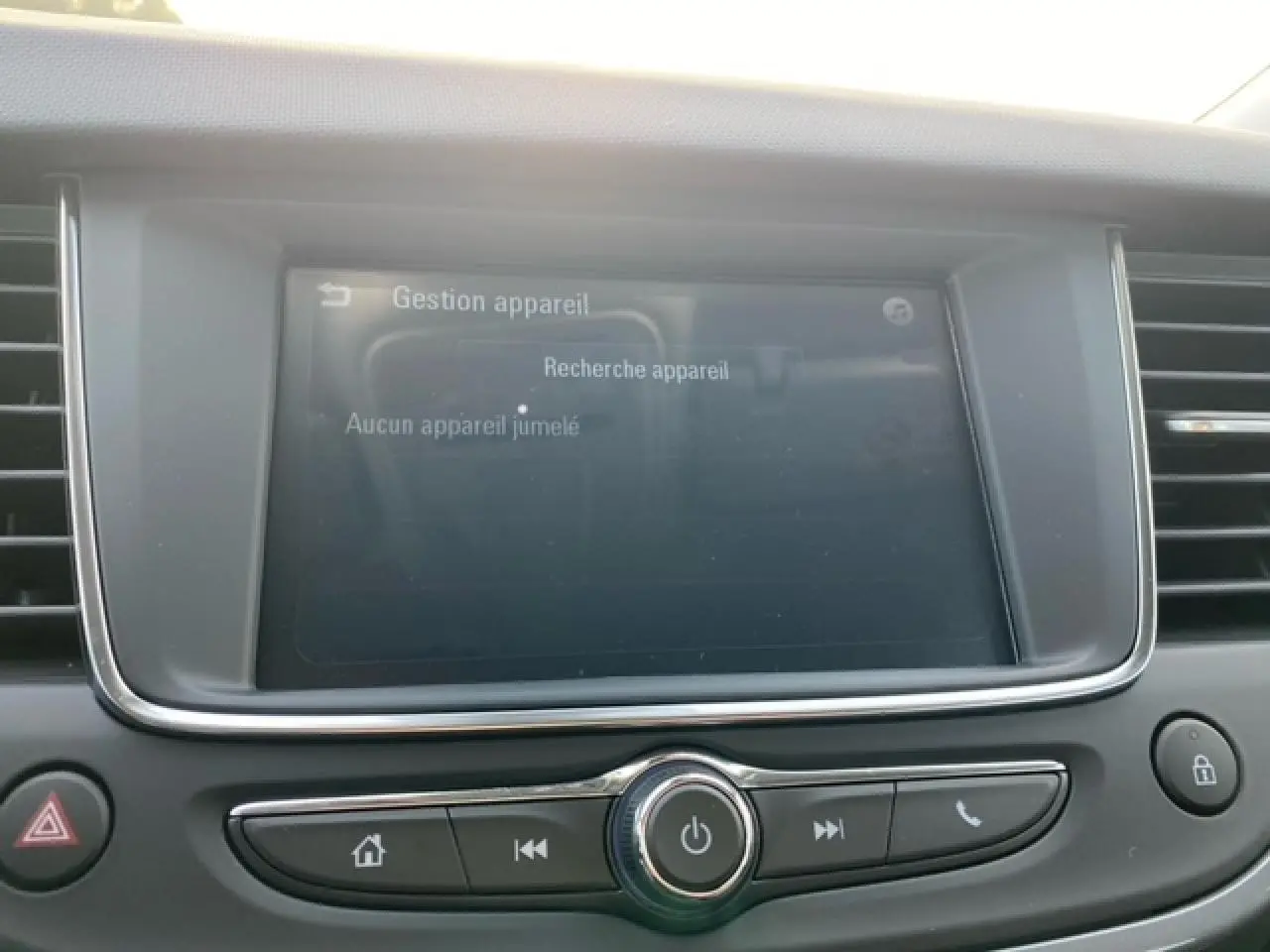 Écran tactile multimédia allumé au centre du tableau de bord de l'Opel Crossland noir métal, vue intérieure frontale.