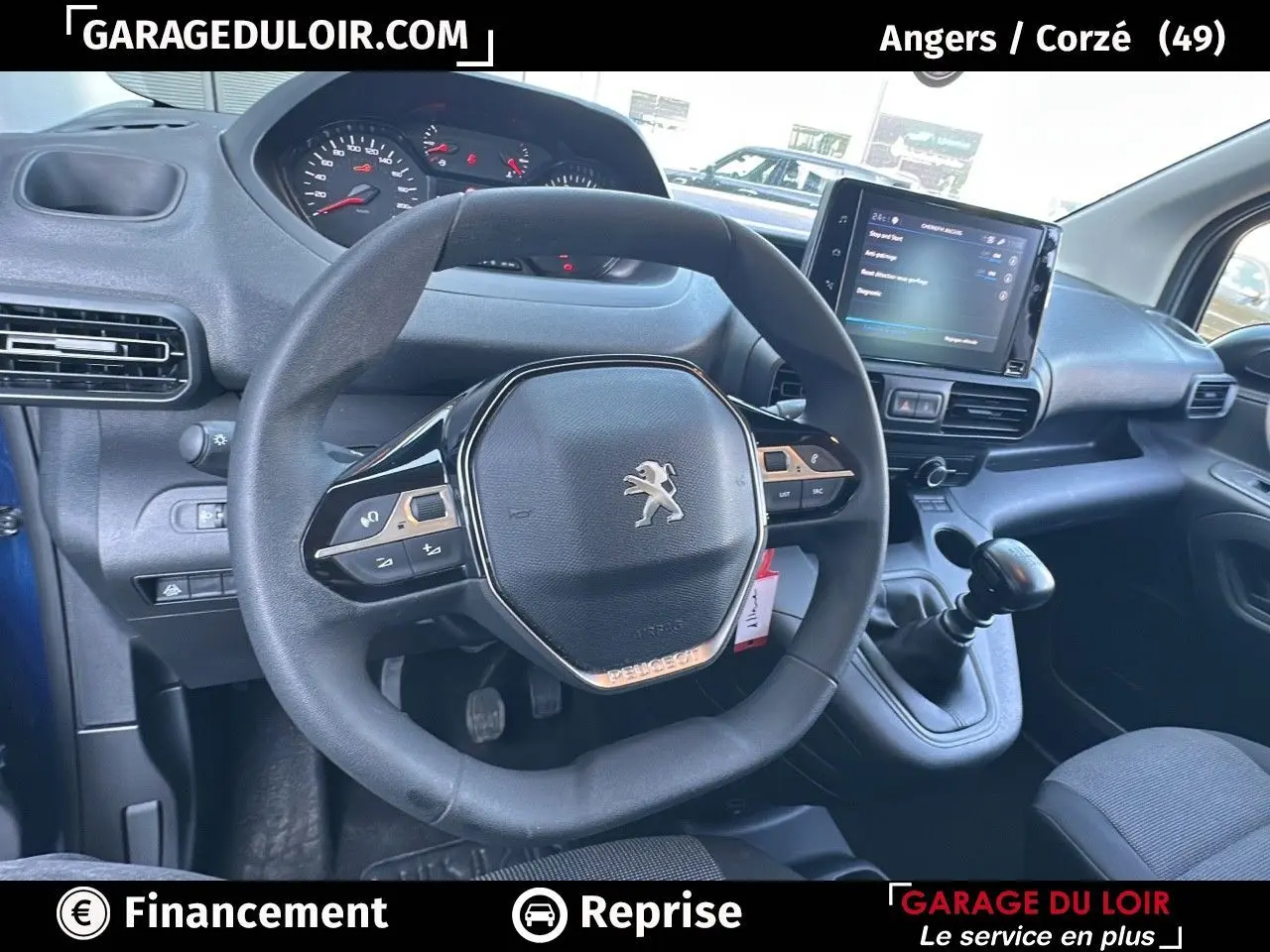 Vue intérieure du volant cuir multifonction et tableau de bord numérique du Peugeot Rifter bleu 2024 avec boîte manuelle.