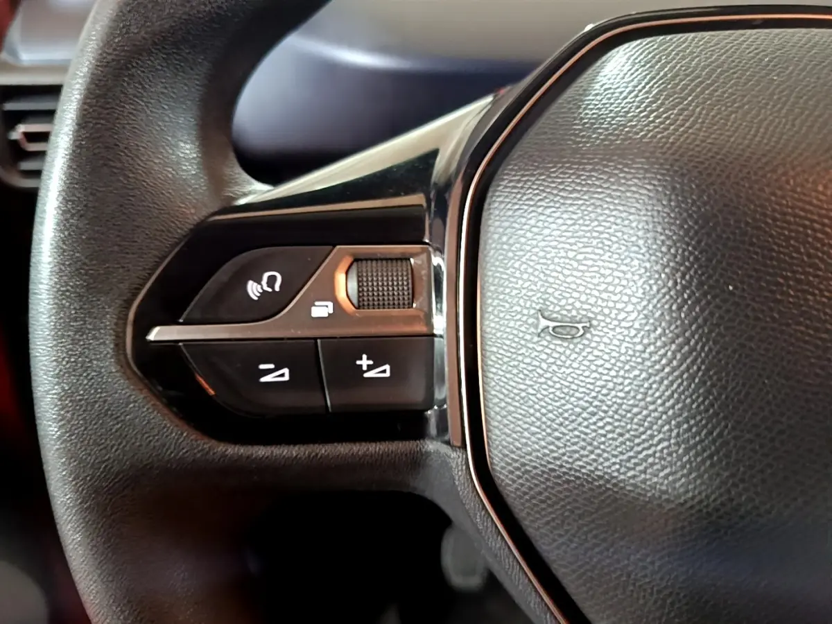 Gros plan sur les commandes gauche du volant noir du Peugeot Rifter BlueHDi 100 Allure 2019.