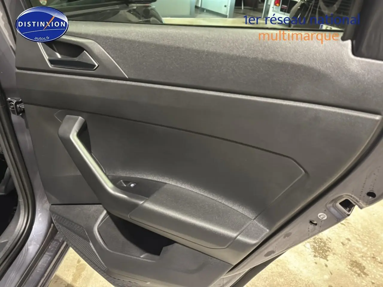 Vue rapprochée de la porte arrière gauche gris cendre de la Volkswagen Polo 2025 avec poignée intégrée et commande de vitre.
