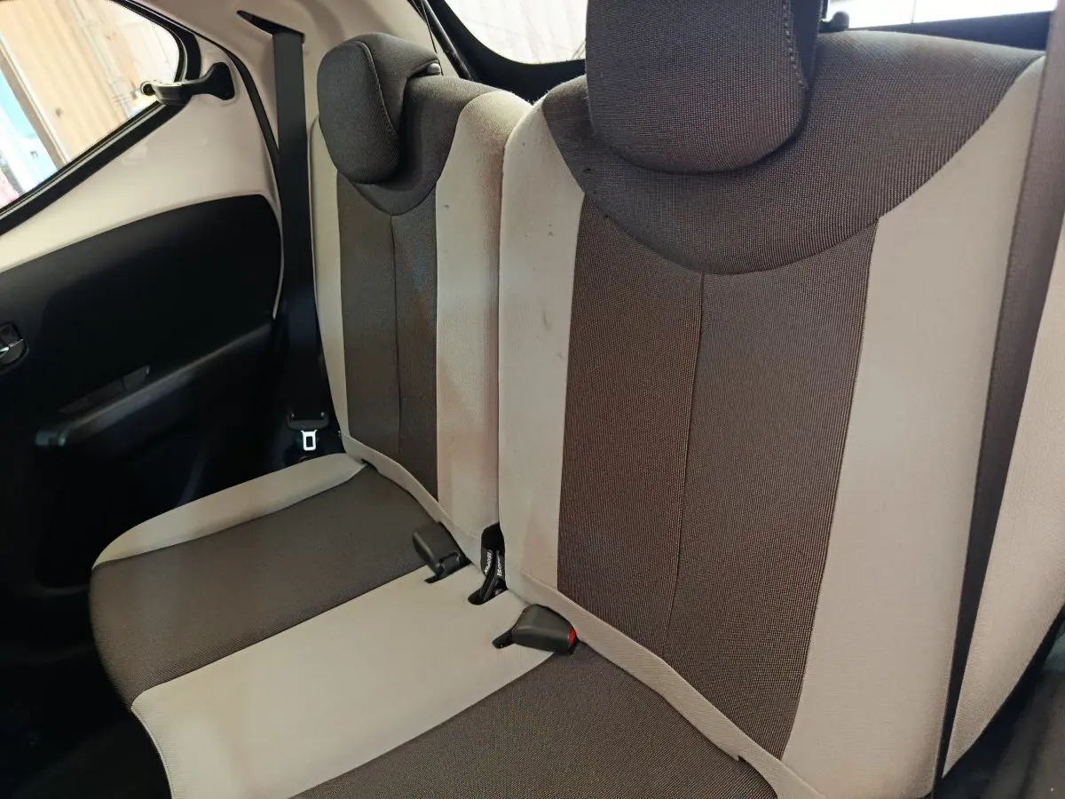 Vue intérieure montrant la banquette arrière bicolore beige et marron de la Toyota Aygo 2016 côté gauche.