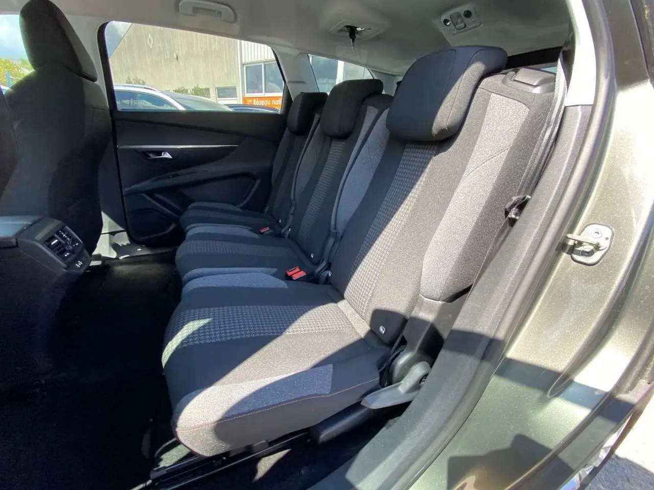 Vue intérieure côté droit sur la banquette arrière en tissu gris du Peugeot 5008 gris clair 7 places.
