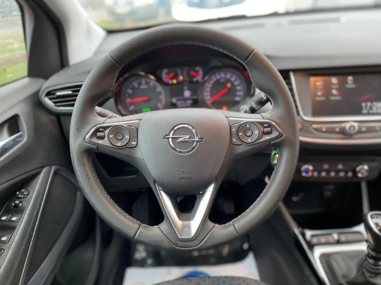Volant en cuir multifonction de l'Opel Crossland 2022, vue centrée sur le tableau de bord et commandes au volant.