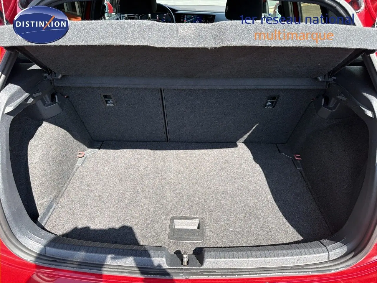 Coffre ouvert vu de l'arrière d'une Volkswagen Polo rouge Roi 2023, montrant un espace de chargement propre et spacieux.