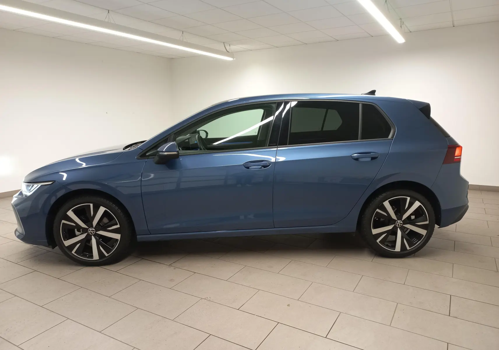 Profil côté gauche d'une Volkswagen Golf 1.5 TSI 116 BVM6 VW Edition bleu Anemone avec jantes alliage 18 pouces.