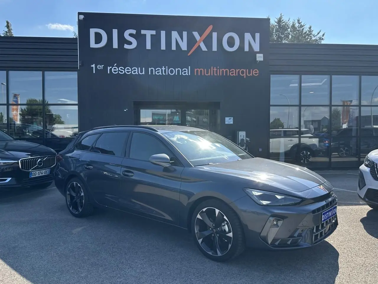 Vue 3/4 avant d'une CUPRA Leon Sportstourer gris magnétique métallisé avec jantes alliage et signature lumineuse Tri-LED visible