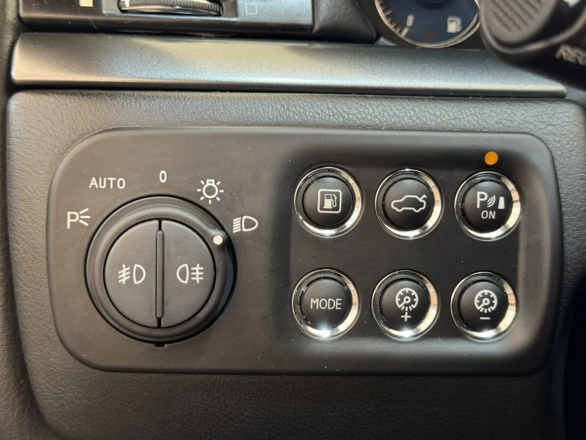 Gros plan sur les commandes noires du tableau de bord de la Maserati Granturismo S 4.7 gris foncé de 2010.