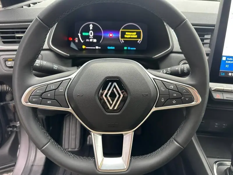 Vue rapprochée du volant multifonction noir du Renault Captur 2025 avec tableau de bord numérique et commandes intégrées.