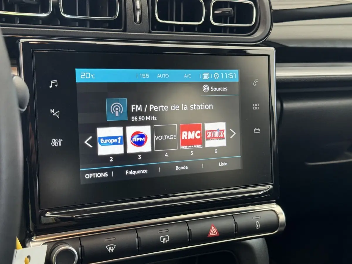Écran tactile central de la Citroën C3 2020 gris foncé, affichant les stations radio FM, vue intérieure frontale.