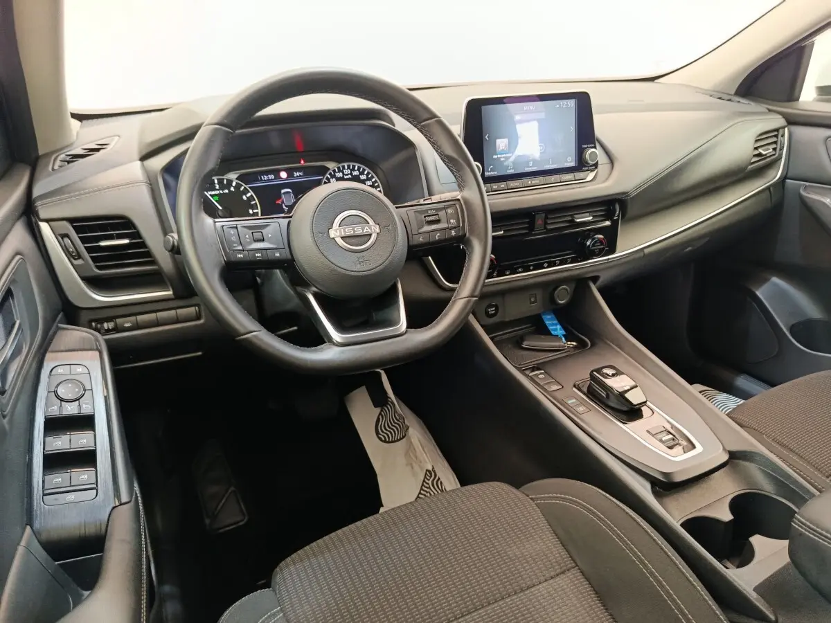 Vue intérieure côté conducteur du Nissan Qashqai e-Power 190 Business Edition 2024, tableau de bord et volant multifonctions noirs.