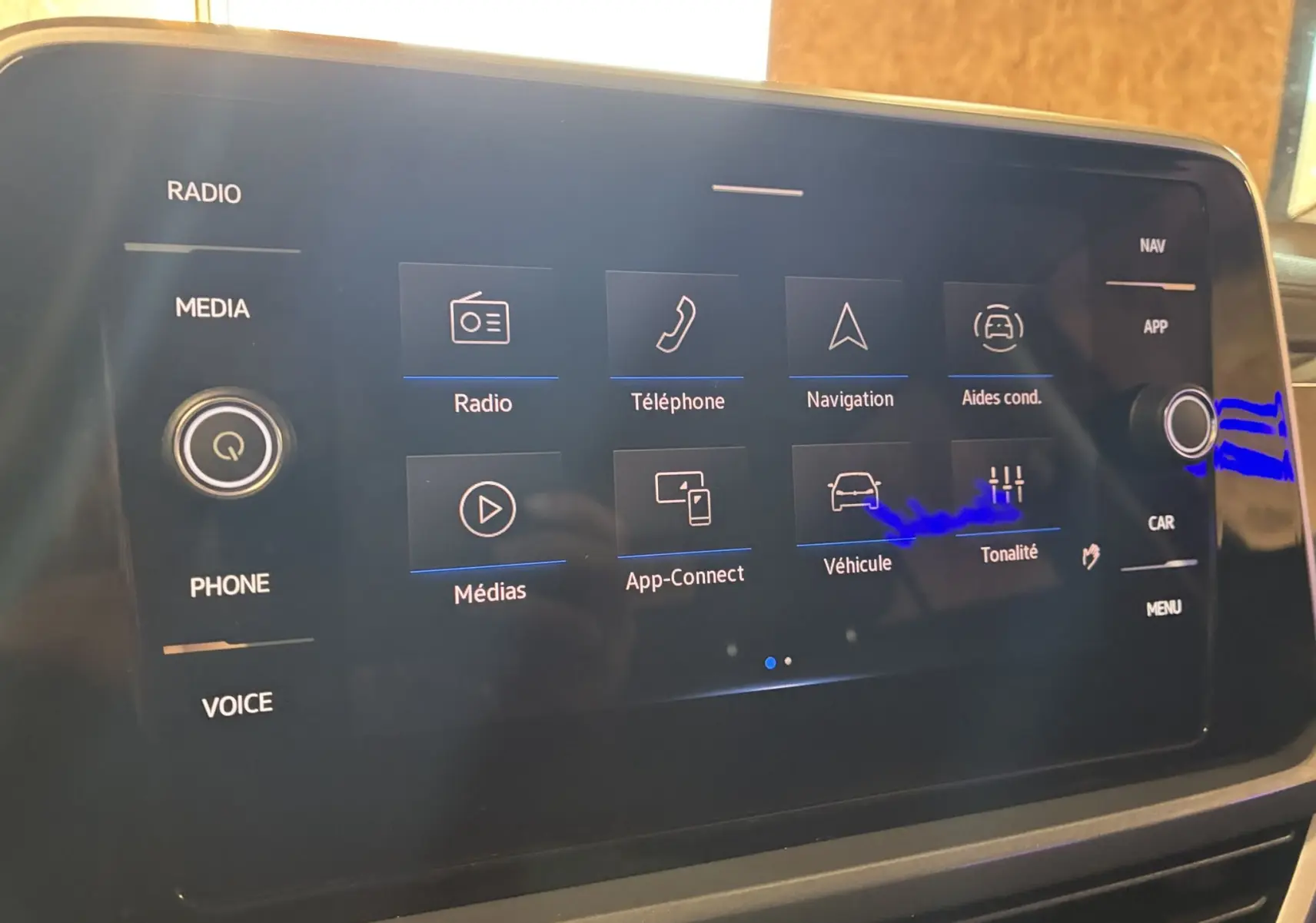 Écran tactile central du Volkswagen T-Roc noir 2025 affichant les options radio, téléphone, navigation et aides à la conduite.