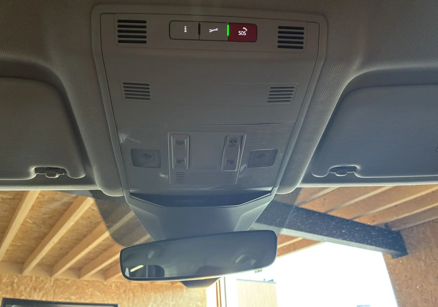 Vue intérieure du toit avec commandes d'éclairage et rétroviseur dans un Volkswagen T-Roc noir 2025.