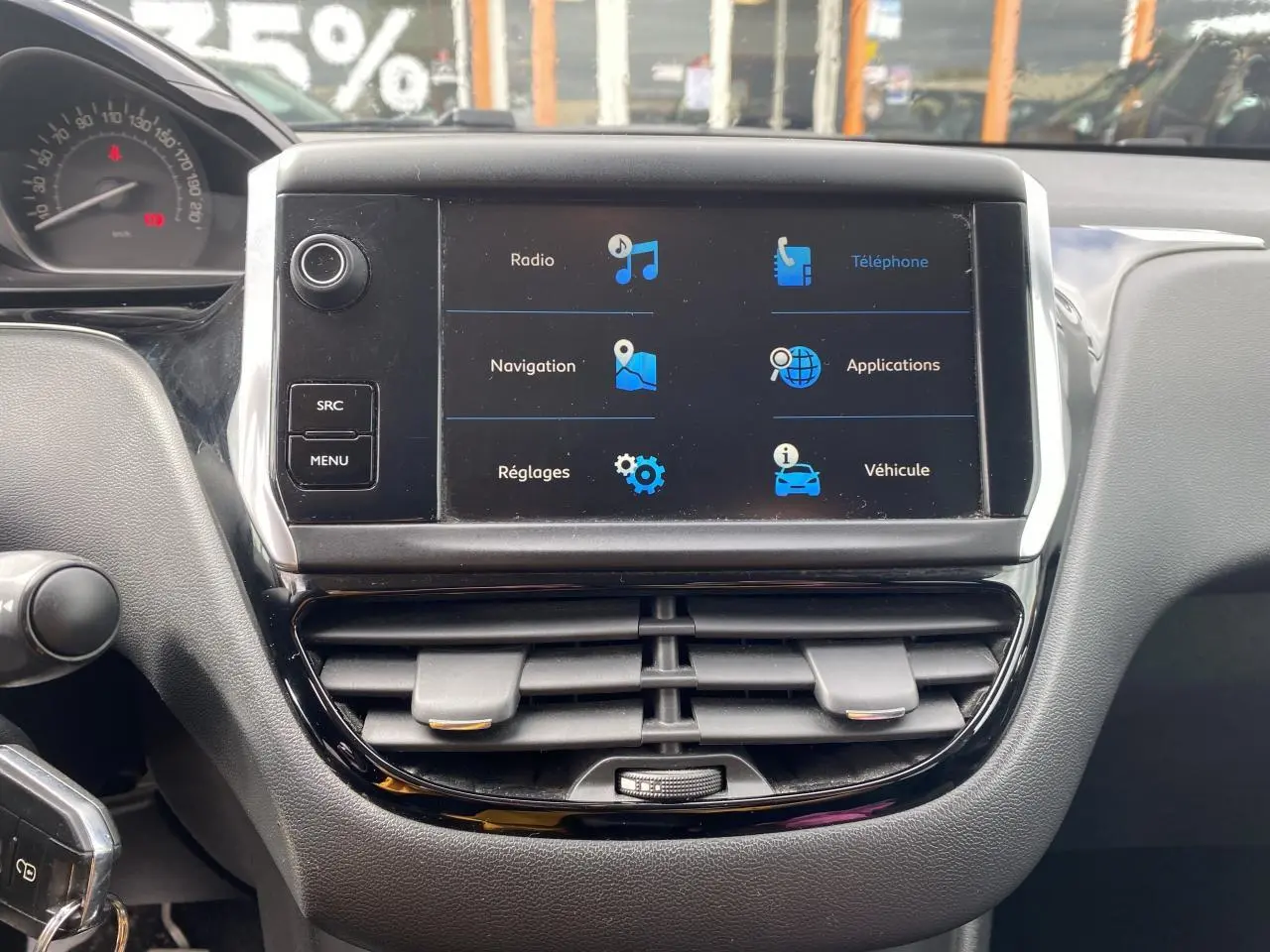 Vue rapprochée du tableau de bord de la Peugeot 208 gris 2018, écran tactile avec menus principaux affichés.