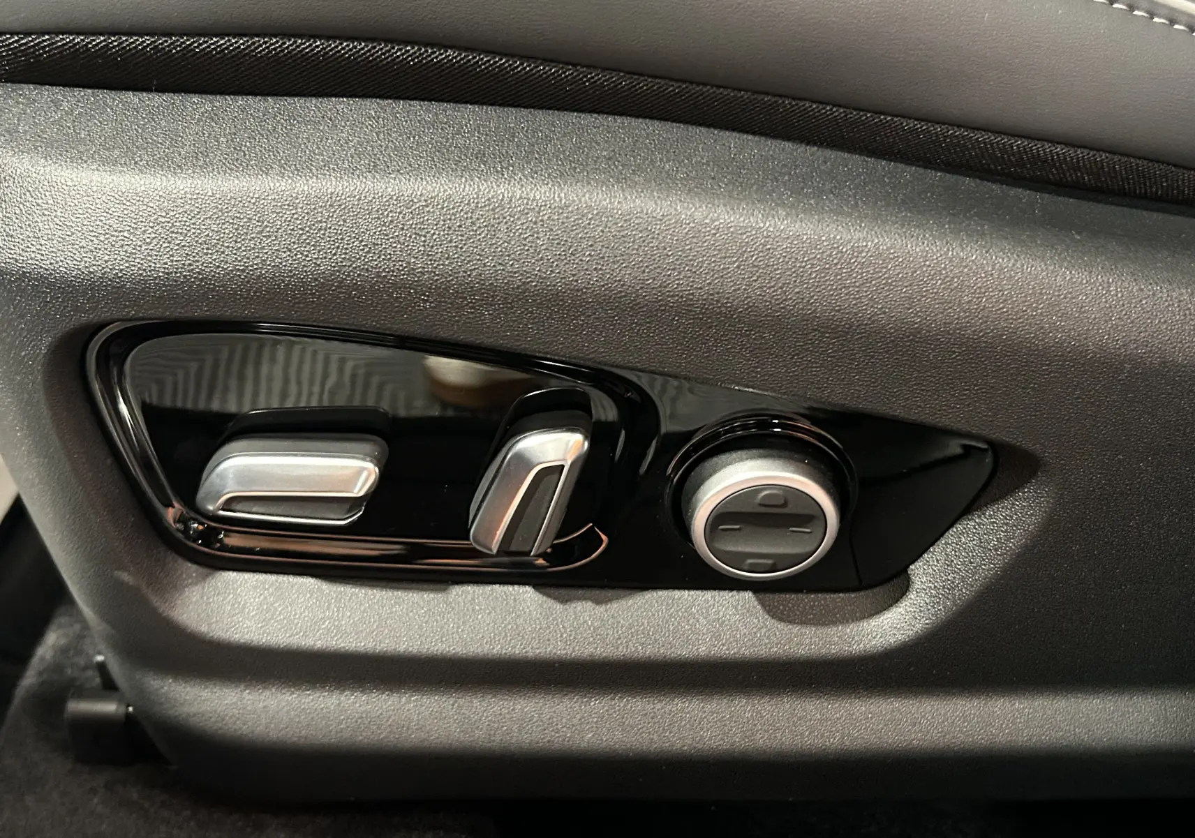 Gros plan sur les commandes de réglage électrique du siège en cuir gris noir du JAECOO J7 TGDI PHEV 279CH EXCLUSIVE.