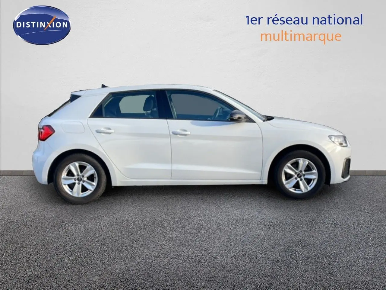 Profil latéral droit d'une Audi A1 Sportback 2023 en blanc glacier métal sur fond neutre.