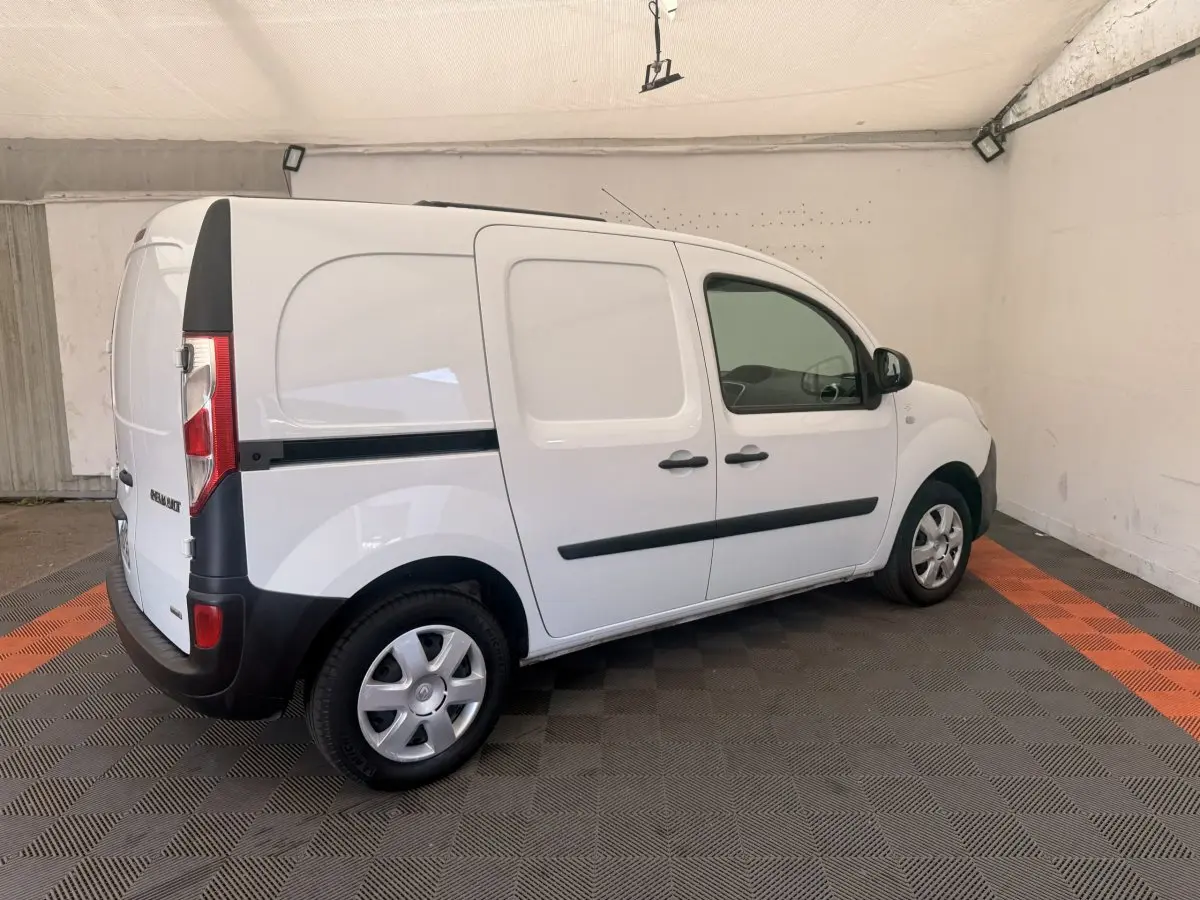 Vue 3/4 arrière droite d’un Renault Kangoo blanc utilitaire avec portes latérales pleines et jantes acier.