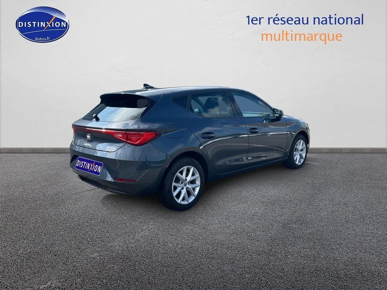 SEAT Leon IV gris magnétique métal vue 3/4 arrière côté droit, soulignant ses lignes modernes et jantes argentées.