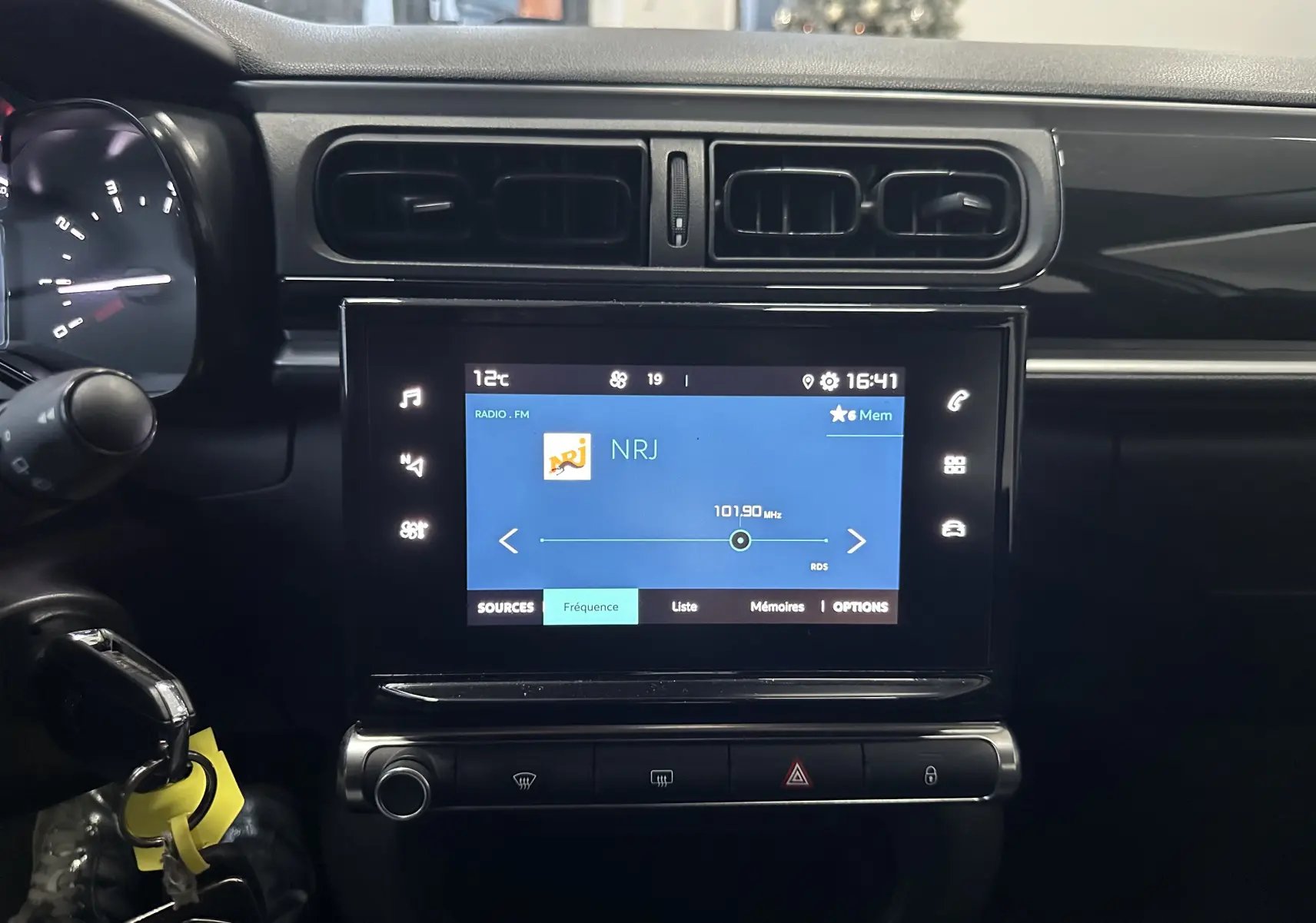 Vue rapprochée de l’écran tactile central et tableau de bord noir d’une Citroën C3 blanche de 2018.